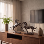 Two metallic horse sculptures in a dark bronze finish, standing on a wooden console table in a modern living room setting.